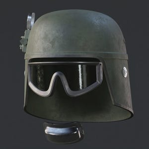 Könnte beinhalten: Olivgrüner Helm mit integrierter Schutzbrille und Kinnschutz. Der Helm hat eine metallische Oberfläche und eine abgenutzte Textur. Zusätzliche Komponenten sind an der Seite angebracht, was auf ein spezialisiertes oder taktisches Design hindeutet.