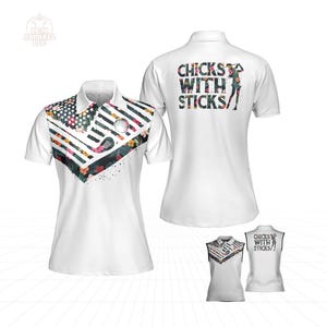 May include: White polo shirt with a colorful floral and geometric design on the collar and shoulders. The back of the shirt features the text "CHICKS WITH STICKS" in a floral pattern, with a silhouette of a golfer.