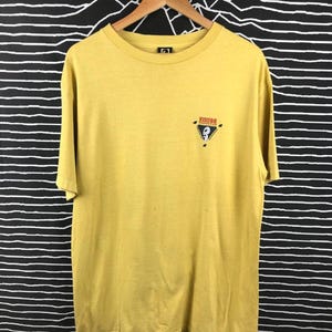 May include: A yellow t-shirt with a black and red logo that says "Visitor Records" on it.