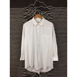 May include: A long-sleeve button-down shirt in a light blue and white pinstripe pattern. The shirt features a classic collar, a single chest pocket on the left side, and a full-length front button placket with matching light-colored buttons.