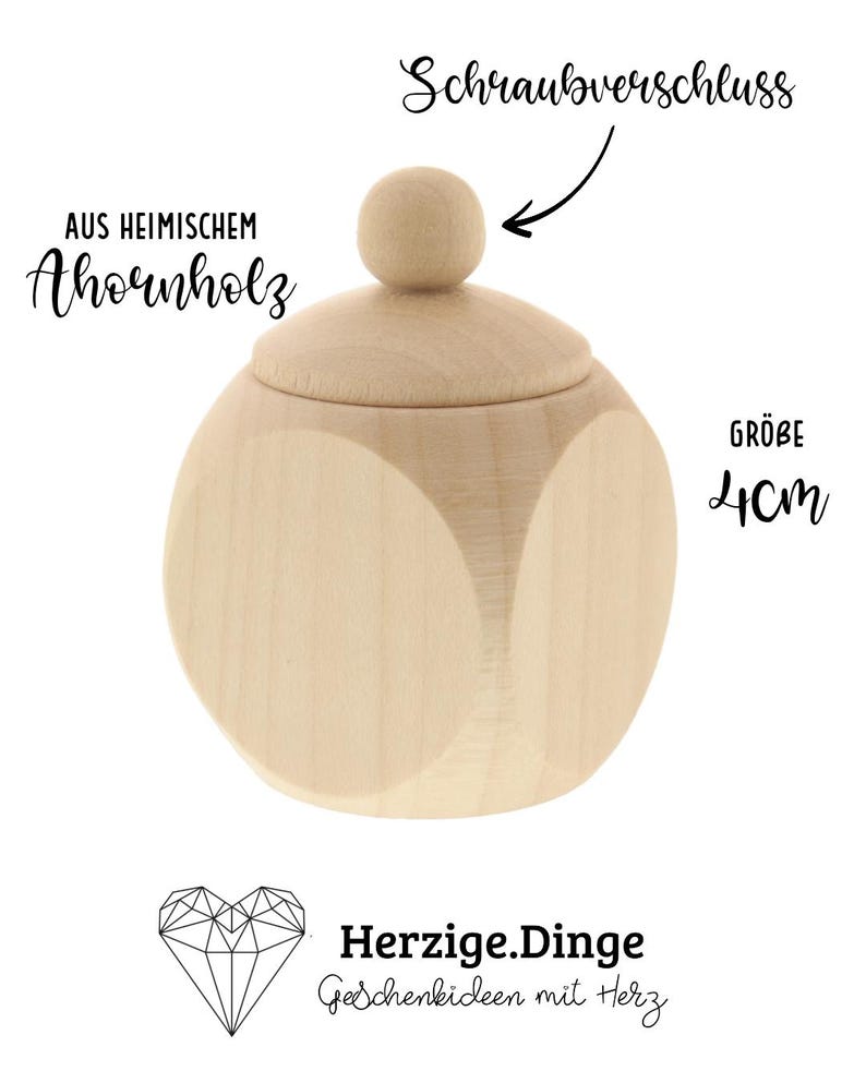 May include: A light-colored wooden container with a rounded shape and a lid. The lid has a small, round knob. The text on the image says "Schraubverschluss", "AUS HEIMISCHEM Ahornholz", "GR&Ouml;BE 4cm", and "Herzige.Dinge Geschenkideen mit Herz".
