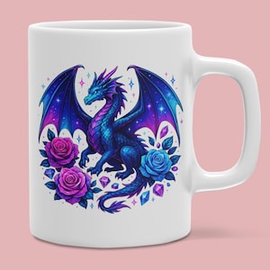 May include: A white ceramic mug featuring a colorful graphic of a blue and purple dragon with large wings. The dragon is surrounded by two purple roses, one blue rose, and several small geometric crystal shapes against a white background.