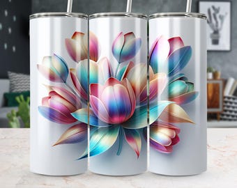 Op de afbeelding: Drie witte roestvrijstalen bekers met een kleurrijk bloemenontwerp. De bloemen zijn een mix van roze, blauw en paars met iriserende accenten.
