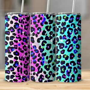 May include: Three stainless steel tumblers featuring a colourful leopard print design. The tumblers are in shades of pink, blue, and turquoise with black spots.