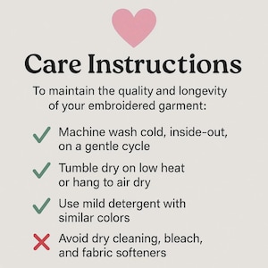 May include: Care instructions for embroidered garments, featuring a pink heart graphic. Text advises washing cold, inside-out, on a gentle cycle, tumble drying on low heat or air drying, and using mild detergent. Avoid dry cleaning, bleach, and fabric softeners.