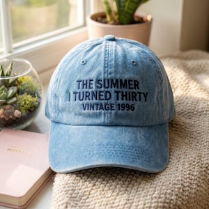 Op de afbeelding: Lichtblauwe baseballcap met de geborduurde tekst "THE SUMMER I TURNED THIRTY VINTAGE 1996". De cap is gemaakt van een zachte stof en heeft een gebogen klep. Een casual accessoire.