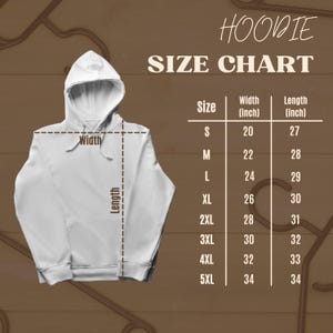 May include: A white hoodie with a size chart. The chart displays measurements in inches for width and length, ranging from size S to 5XL. The hoodie has a hood and a front pocket.