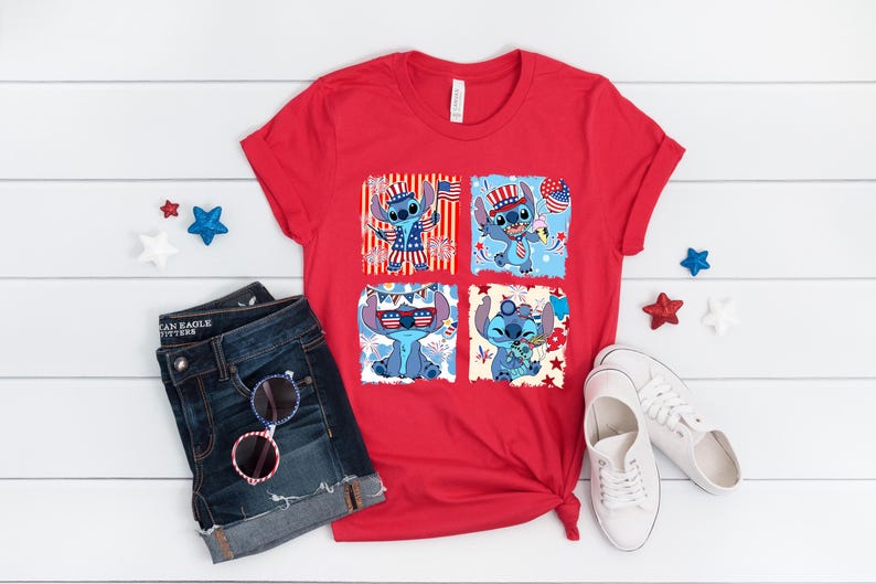 May include: A red t-shirt with four squares depicting the cartoon character Stitch in patriotic designs. The shirt is styled with denim shorts, sunglasses, and white trainers. Decorative stars are scattered around the items.