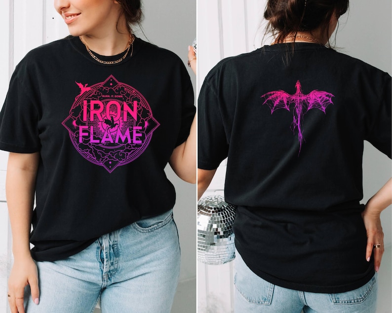 May include: Black t-shirt with a pink and purple gradient design. The front of the shirt features a circular design with the text "IRON FLAME" inside. The back of the shirt features a pink and purple dragon design.