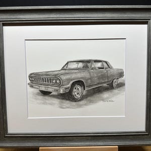 May include: A black and white pencil drawing of a classic car, a Chevrolet Chevelle, in a gray frame.