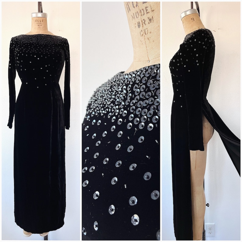 May include: A long black velvet gown with a high neckline and long sleeves. The gown is embellished with silver sequins in a graduated pattern.