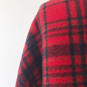 May include: Red, black, and green plaid fabric with a fuzzy texture.