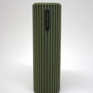 May include: A green cylindrical container with vertical grooves and a black label that says "Your Name".