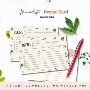Peut inclure: Deux cartes de recettes imprimables avec un design minimaliste. Les cartes sont de couleur crème avec du texte noir et des illustrations de raisins, d'olives et d'autres articles de cuisine. Le texte sur les cartes indique "Carte de recette" et comprend des sections pour "Nom du plat", "Servir", "Temps de préparation", "Temps total", "Température du four", "Ingrédients" et "Instructions".