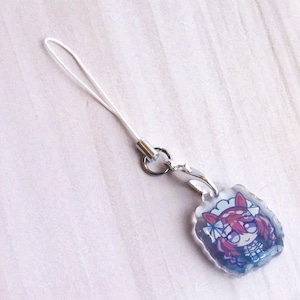 May include: A clear acrylic charm featuring a cartoon character with red hair and animal ears, attached to a silver-toned metal lobster clasp and a white nylon loop cord. The charm has a scalloped edge and a glossy finish over the printed design.