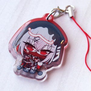 May include: A clear acrylic charm featuring a stylized anime character with white hair, red eyes, and a red mask. The character wears a dark hooded outfit with red accents and stitching details. A silver metal lobster clasp and a red cord are attached.