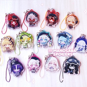 May include: A collection of thirteen acrylic charms featuring various anime-style characters with colorful hair and outfits, each attached to a small colored cord loop. The text MANOSABA SPOILERS is printed in white on a pink background in the center.