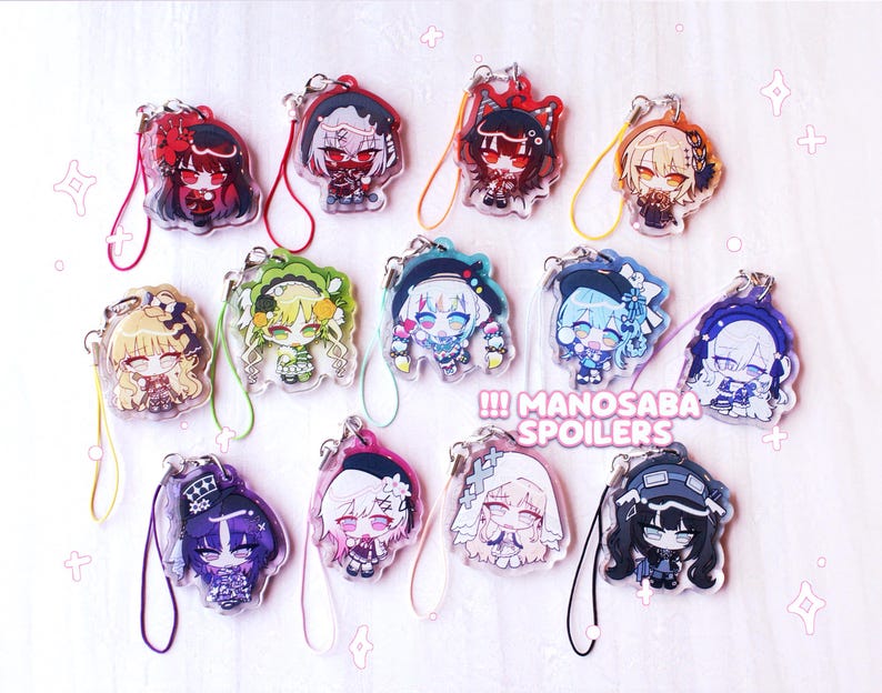 May include: A collection of thirteen acrylic charms featuring various anime-style characters with colorful hair and outfits, each attached to a small colored cord loop. The text MANOSABA SPOILERS is printed in white on a pink background in the center.