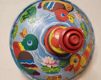 Vintage German metal spinning toy top from the 60s.