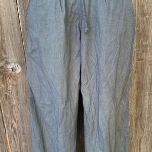 May include: A pair of dark gray drawstring pants with a relaxed fit.