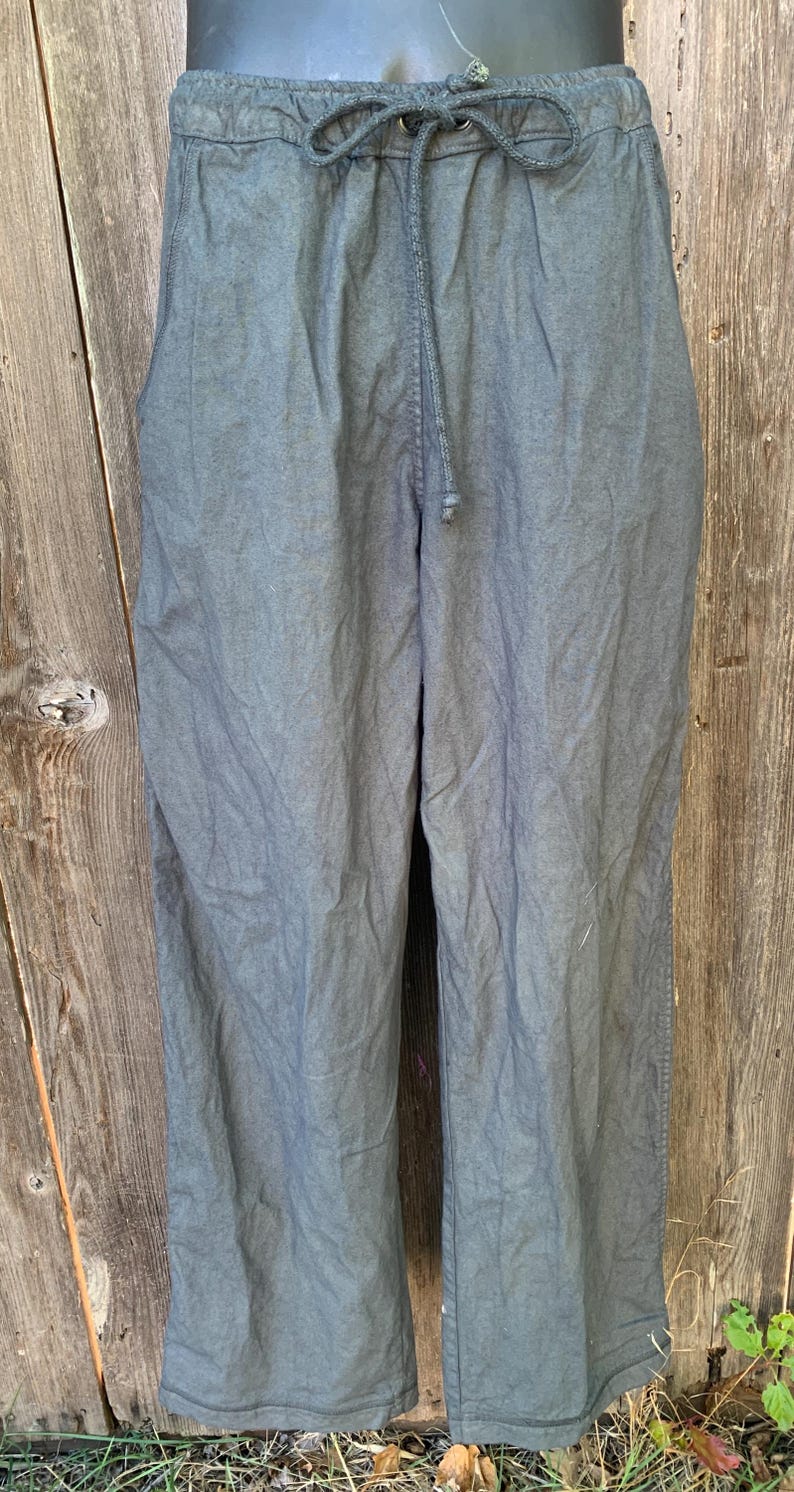 May include: A pair of dark gray drawstring pants with a relaxed fit.