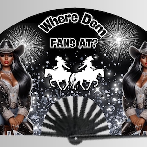 May include: A black and white hand fan with a glittery background. The fan features two women wearing cowboy hats and riding horses. The text "Where Dem Fans At?" is written in white on a black background.