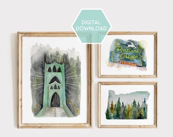 May include: Set of three framed watercolor prints. The prints depict a green bridge, a Portland Oregon sign, and a forest scene. The prints are in wooden frames and are labeled "DIGITAL DOWNLOAD".