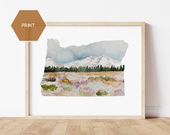 May include: Watercolor print of the Oregon landscape, framed in a light wood. The artwork depicts snow-capped mountains, a forest, and a field of wildflowers in shades of green, purple, and tan. The word "PRINT" is in a brown hexagon in the upper left corner.