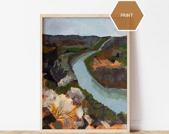 May include: A painting of a river winding through a landscape. The river is a light blue color and the landscape is a mix of greens, browns, and oranges. The painting is framed in a light wood frame.