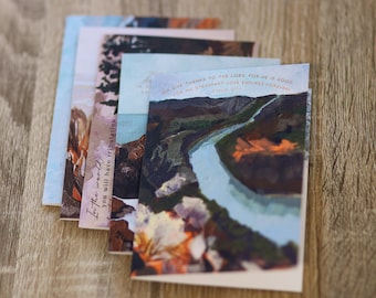 May include: A stack of four cards featuring a watercolour painting of a river and trees. The text on the bottom card reads "Give thanks to the Lord, for he is good, for his steadfast love endures forever. Psalm 107:1."