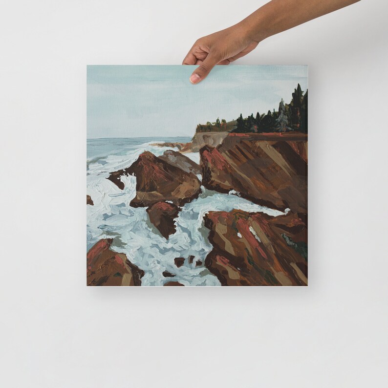 May include: A painting of a rocky coastline with crashing waves. The water is a light blue and the rocks are a dark brown. The sky is a light blue and there are trees in the background.