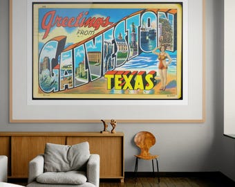 May include: A framed vintage postcard print with the words "Greetings from Galveston Texas" in large, colorful letters. The postcard features illustrations of the city and a woman in a swimsuit. The print is displayed in a living room setting.