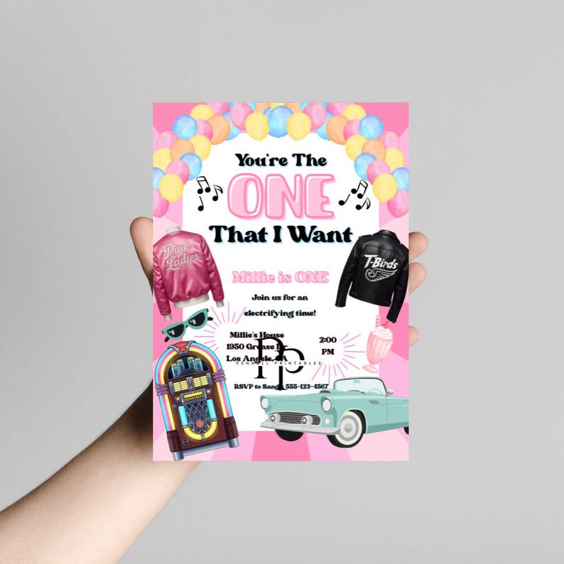 May include: A pink invitation card with the text "You're The ONE That I Want" and "Millie is ONE". The card features illustrations of a pink jacket, a black jacket, a jukebox, sunglasses, a milkshake, and a vintage car.