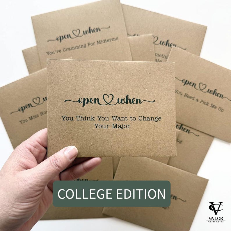 May include: A collection of kraft paper cards with the phrase "open when" and various prompts in black script. One card reads "You Think You Want to Change Your Major." The cards are labeled "College Edition."