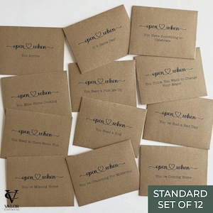 May include: A set of twelve kraft paper envelopes with the words "open when" and various prompts printed in black script. Prompts include "You Arrive," "It's Game Day," and "You Have Something to Celebrate." The set is labeled "STANDARD SET OF 12."