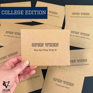 May include: Kraft paper cards with the text "OPEN WHEN" and various prompts, including "You Get Your First 'A'" and "Finals are Over!". The words "COLLEGE EDITION" are in a blue rectangle. The Valor Craftworks logo is in the bottom left corner.