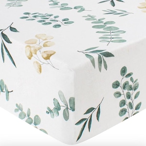 May include: White fitted crib sheet with a green and yellow watercolor leaf pattern.