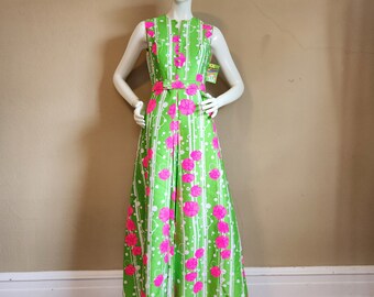 May include: A long green maxi dress with a white and pink floral print. The dress has a sleeveless design and a fitted bodice.