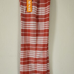 May include: Red and white plaid pants with a "PERSONAL" tag attached. The pants have a wide leg style.