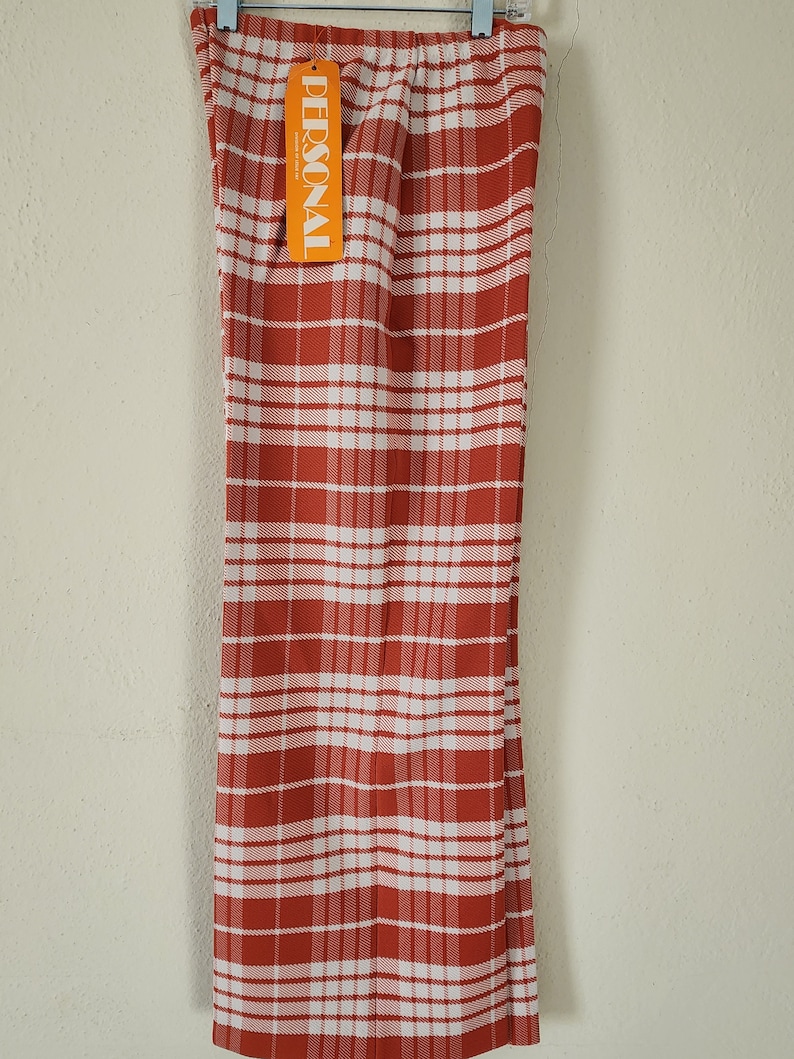 May include: Red and white plaid pants with a "PERSONAL" tag attached. The pants have a wide leg style.