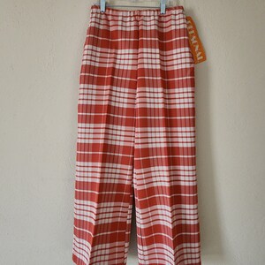 May include: Red and white plaid pants with a white elastic waistband and a "PERSONAL" tag attached.
