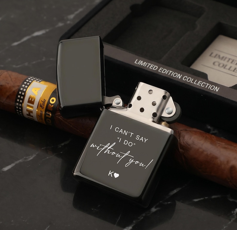 May include: A black, open lighter with the text "I CAN'T SAY 'I DO' without you!" and a heart symbol. A cigar rests beside the lighter, and the box reads "LIMITED EDITION COLLECTION".