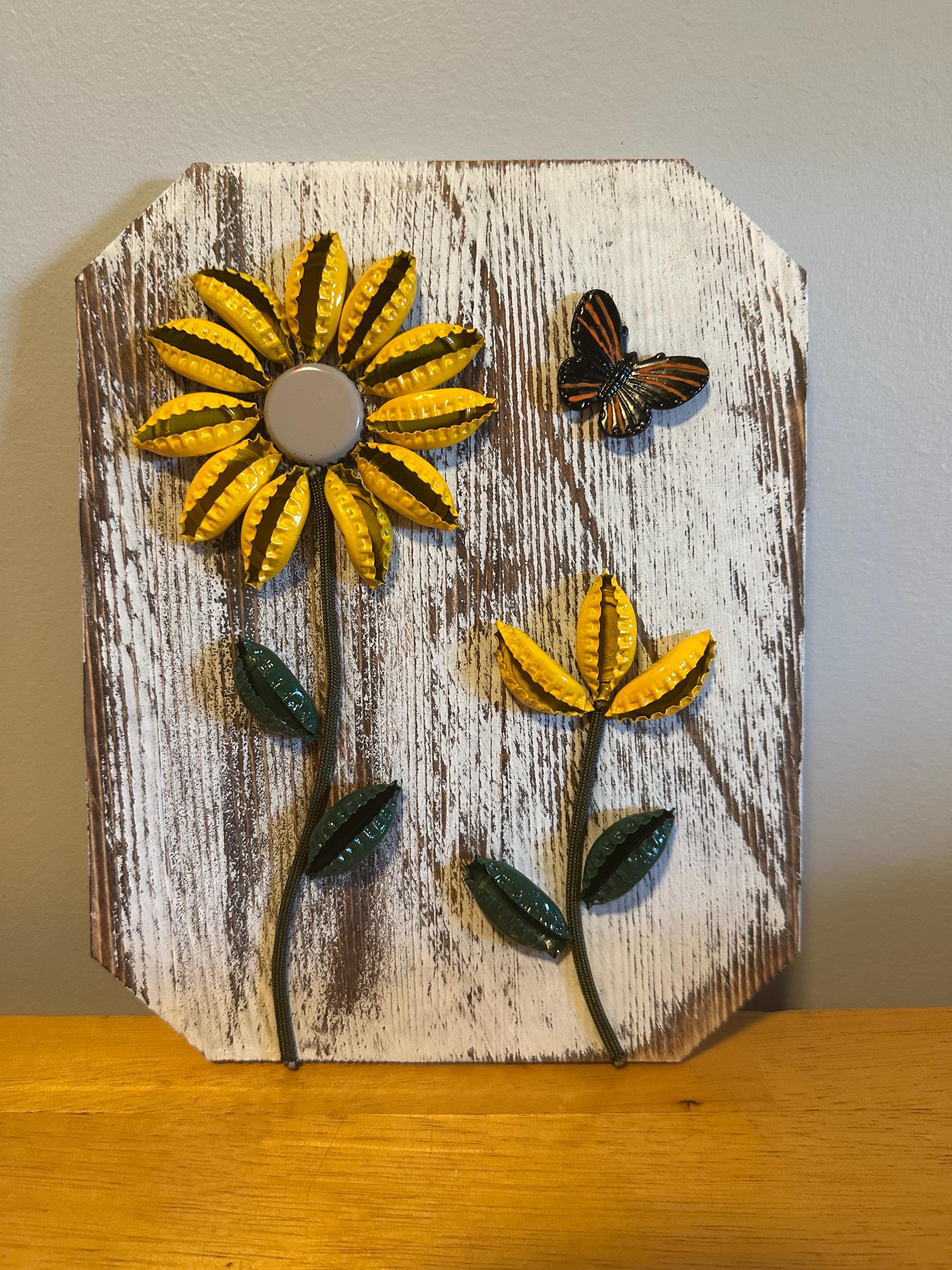 Handcrafted wooden flower display, made from recycled bottle caps, art.