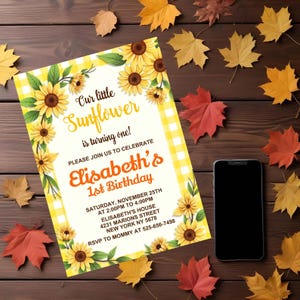May include: A yellow and white checkered invitation with sunflowers and the text "Our little Sunflower is turning one!"  Please join us to celebrate Elisabeth's 1st Birthday. Saturday, November 25th at 2:00pm to 4:00pm. Elisabeth's House, 4231 Marions Street, New York NY 5678. RSVP to Mommy at 525-656-7498.