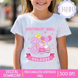 May include: White t-shirt featuring a pink and purple birthday design. The graphic includes the words "BIRTHDAY GIRL", the number 3, a pig character, balloons, a cake, and the name "DELANEY" on a banner.