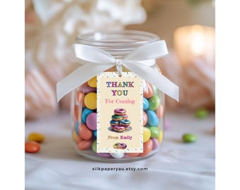 May include: A glass jar filled with colorful candies, tied with a white ribbon, and a tag that reads "THANK YOU For Coming" with a stack of donuts. The tag also says "From Emily".