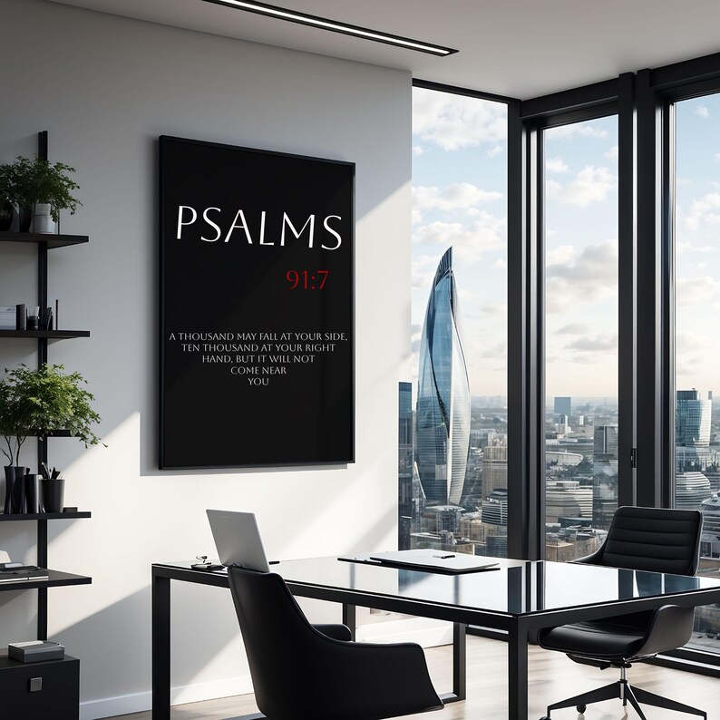 May include: Black and white framed print with the text "PSALMS 91:7" and a quote from the Bible in red text. The print is hanging on a white wall in a modern office setting.