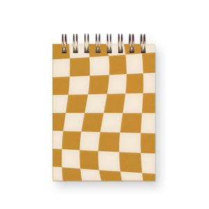 May include: A spiral bound notebook with a checkered pattern in shades of brown and white. The pattern is a wavy, optical illusion design.