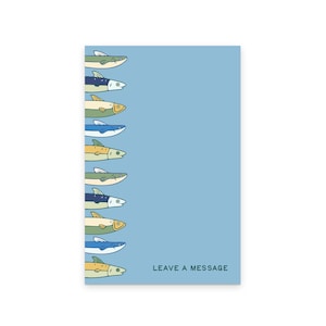 May include: A light blue card with a row of cartoon fish in various colors along the left side. The fish are green, blue, yellow, and white. The text "LEAVE A MESSAGE" is printed in black at the bottom right.