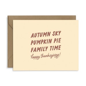 May include: A yellow card with the text "AUTUMN SKY PUMPKIN PIE FAMILY TIME happy thanksgiving!" in brown lettering.